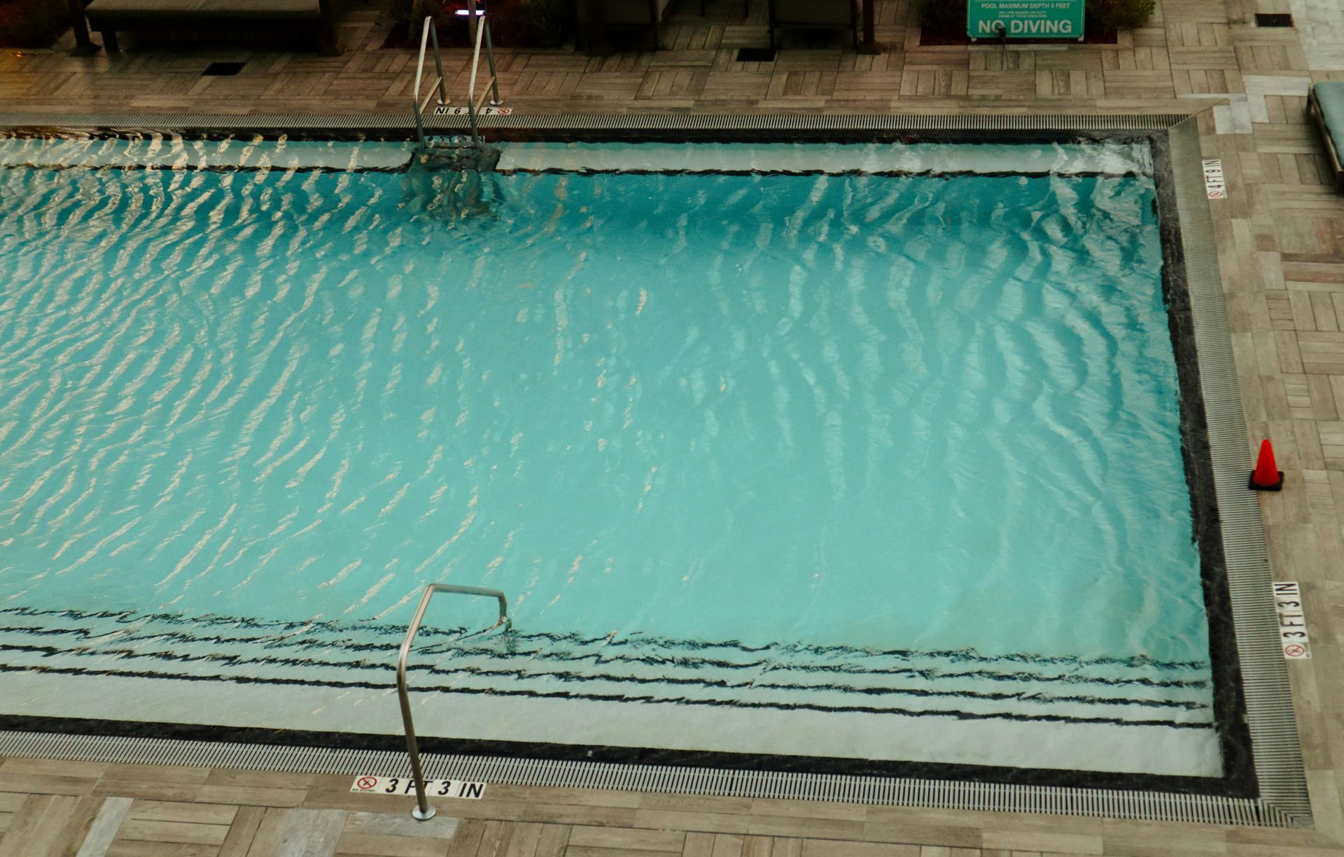 Flexible hose attached to a pool vacuum cleaner, ready for efficient and thorough cleaning of the pool floor.