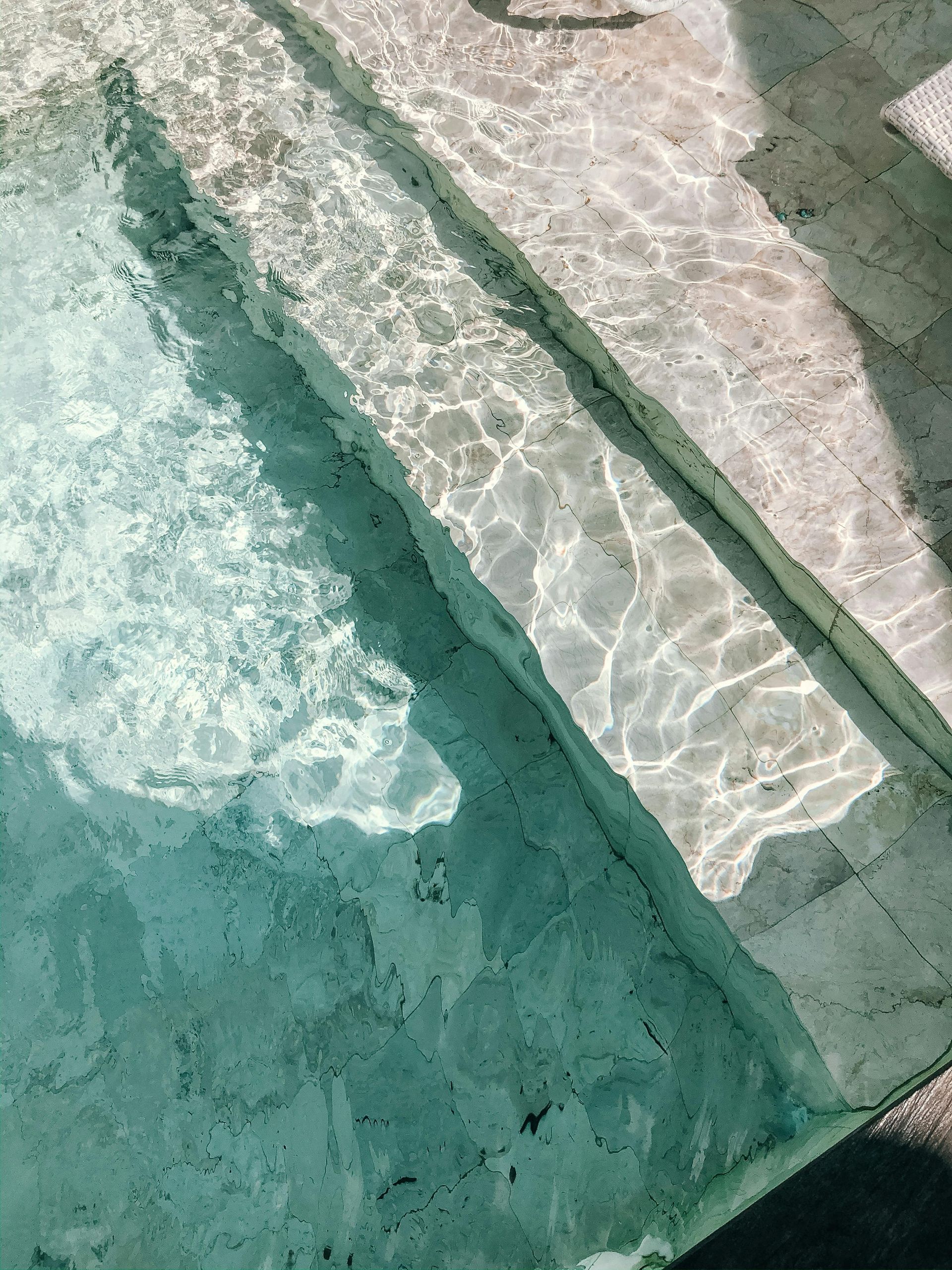 Flexible hose attached to a pool vacuum cleaner, ready for efficient and thorough cleaning of the pool floor.