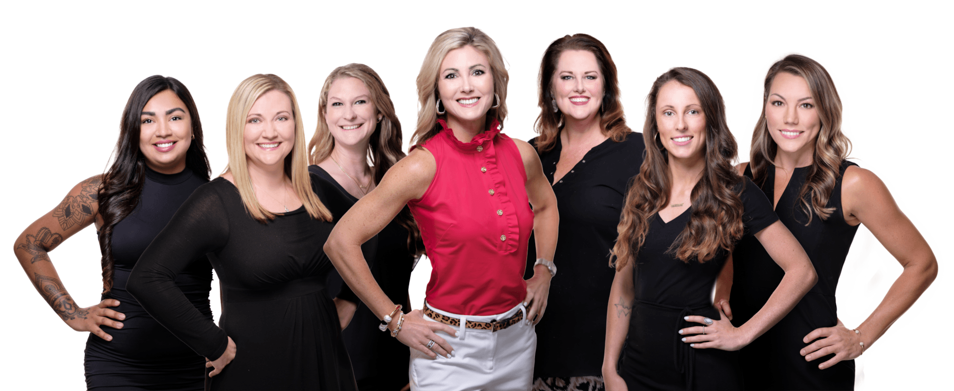 A group of women standing next to each other with their hands on their hips.