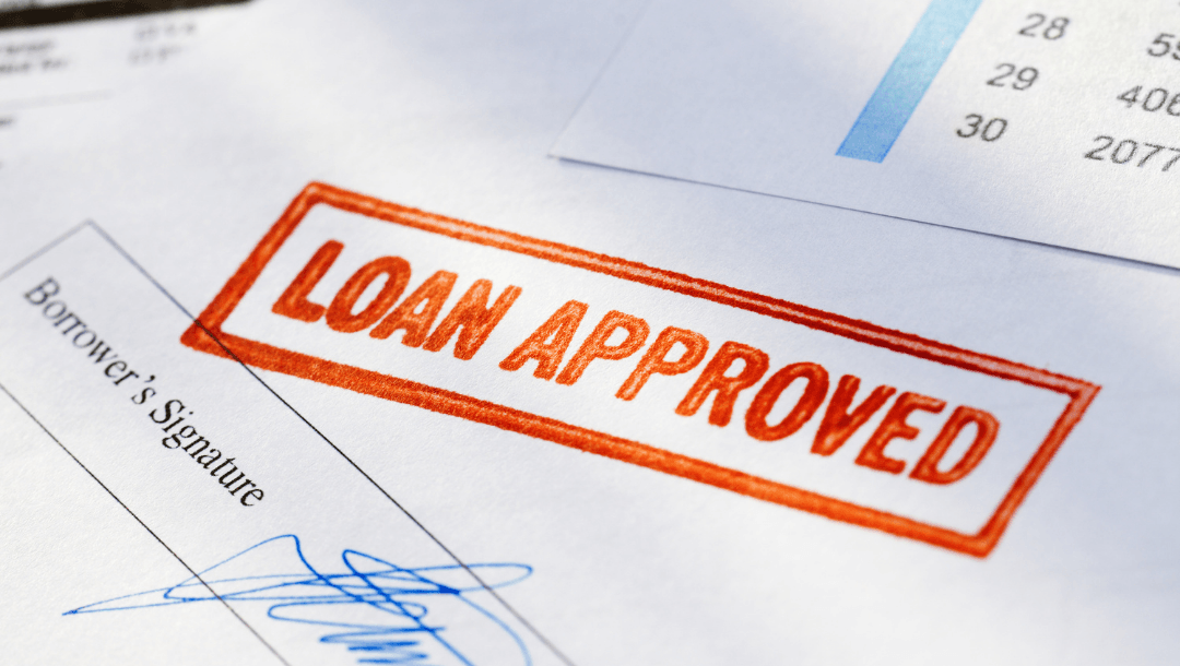 A loan approved stamp is on a piece of paper