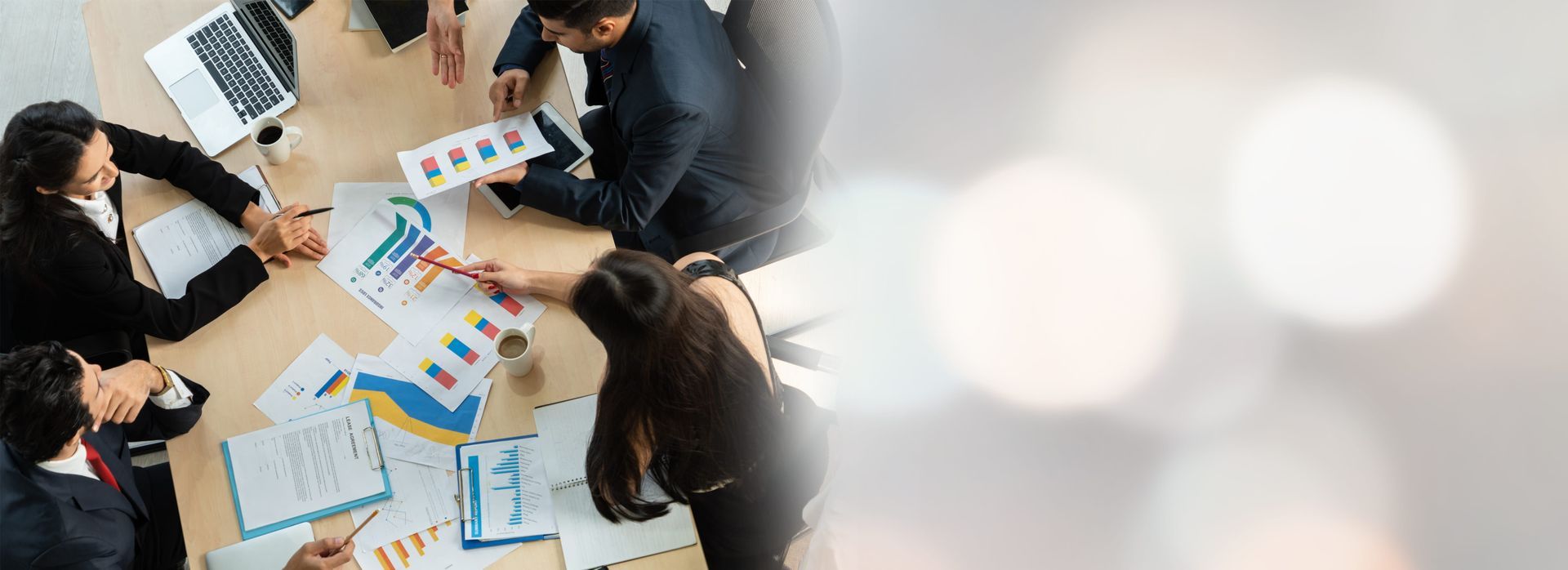 Business colleagues reviewing charts and documents at a table.