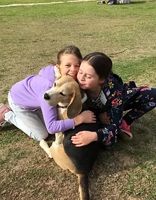 young girls hugging a dog