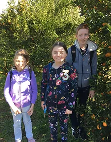 young family members standing under a tree