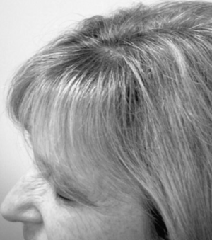 A close up of a woman 's hair in a black and white photo.