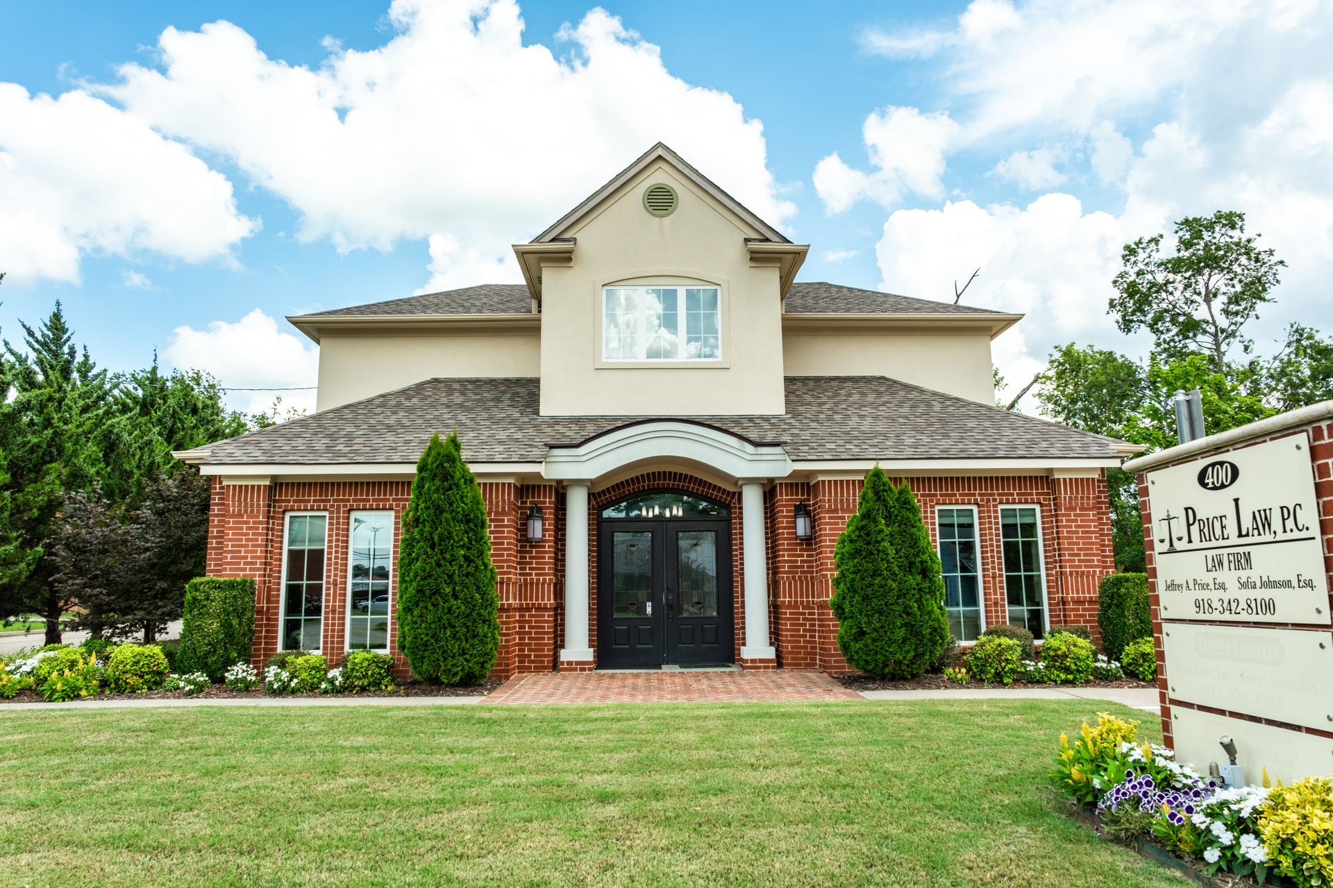 Oklahoma City skyline reflecting in a water feature at sunset; pink and blue sky, modern buildings.