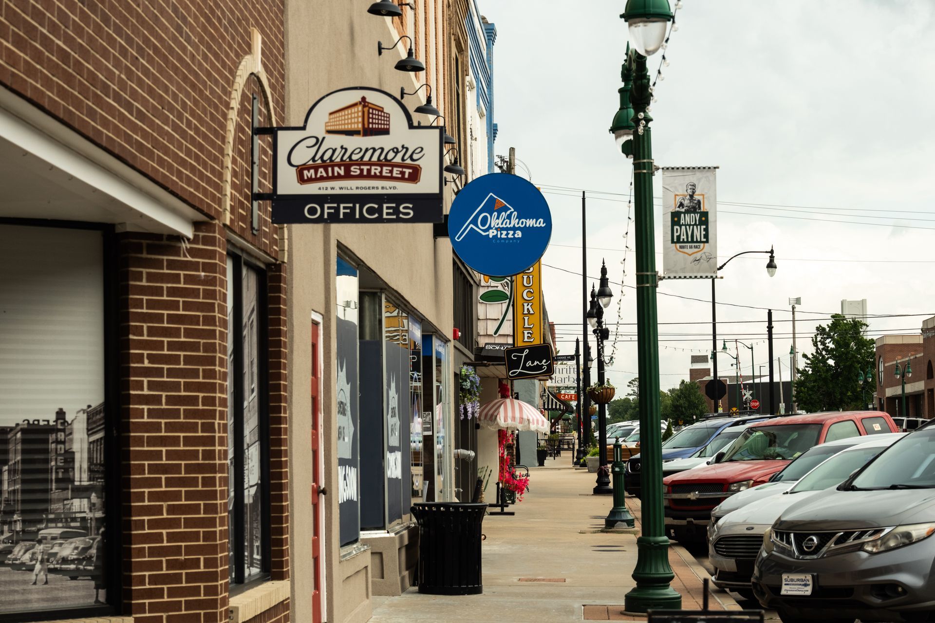 Statue of a man on a rearing horse in front of a capitol building dome and an American flag.