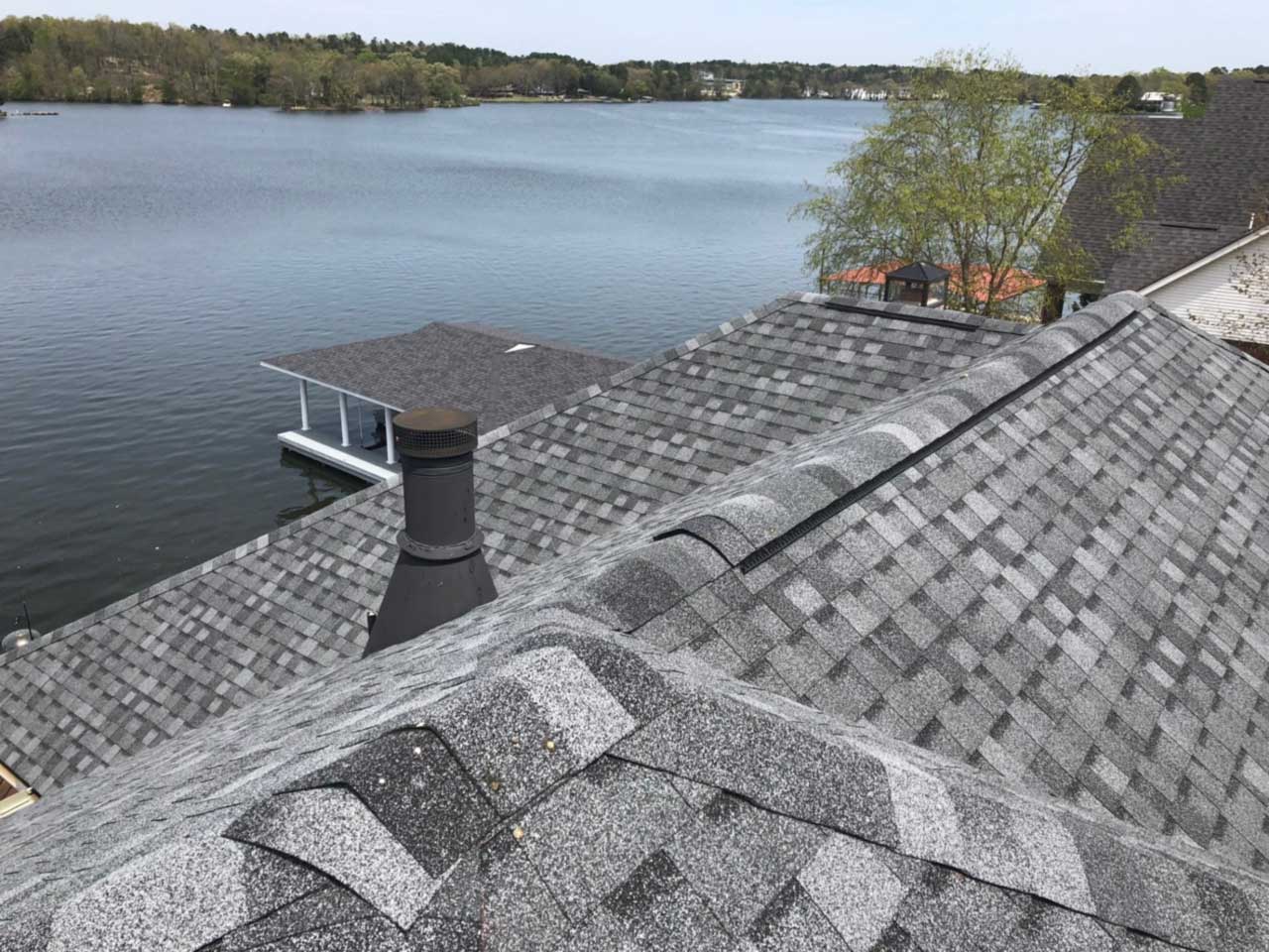 A view of a lake from the roof of a house.