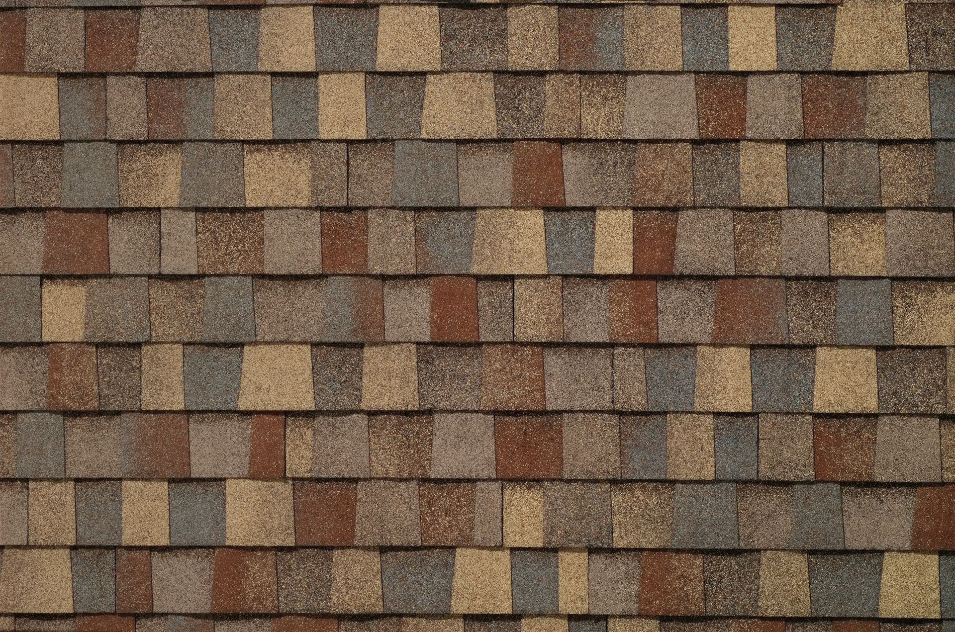 A close up of a roof with brown and tan tiles