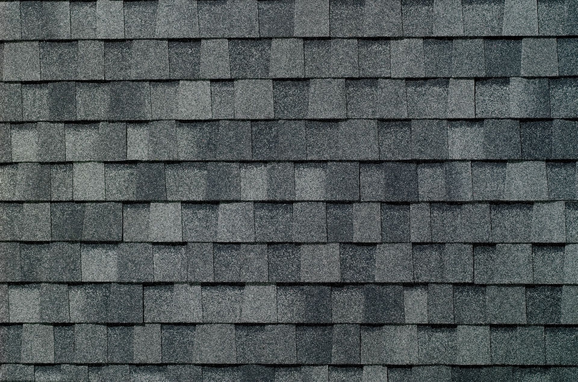 A close up of a roof with a lot of shingles on it.