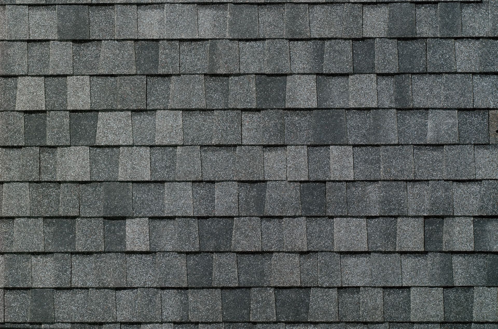 A close up of a roof with a lot of shingles on it.