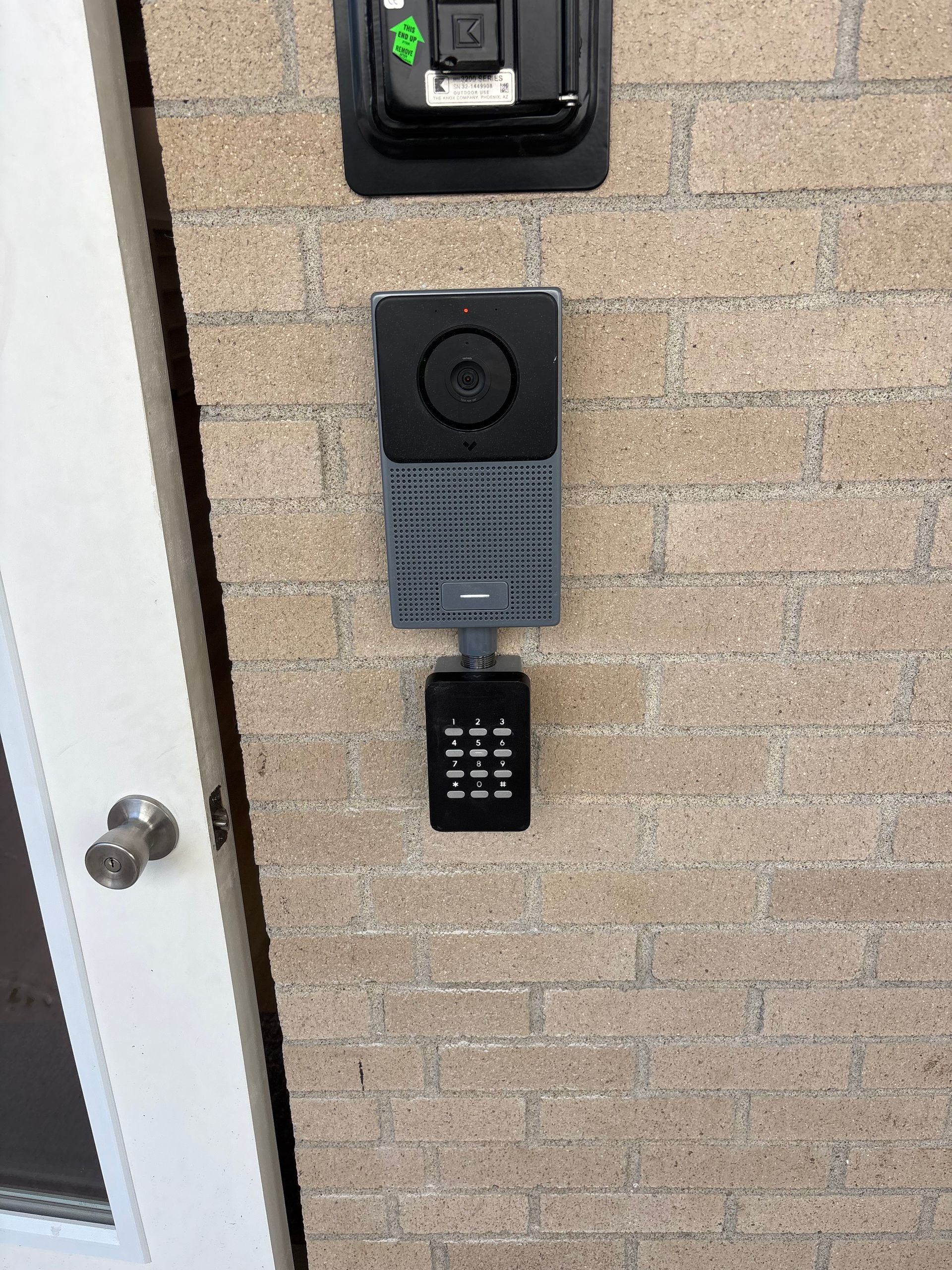 A ladder is sitting in a hallway next to a door.