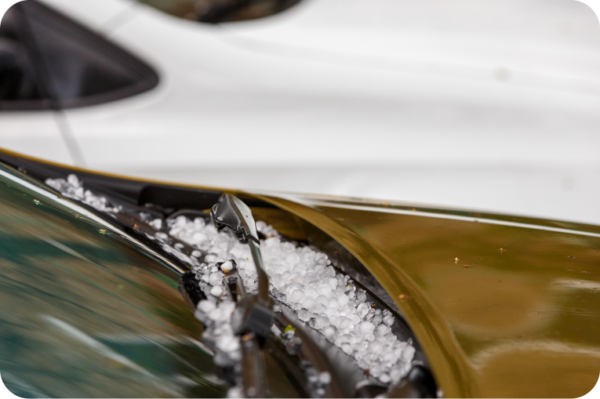 A close up of a car with hail on it