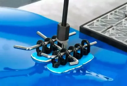 A bunch of screws are sitting on top of a blue surface