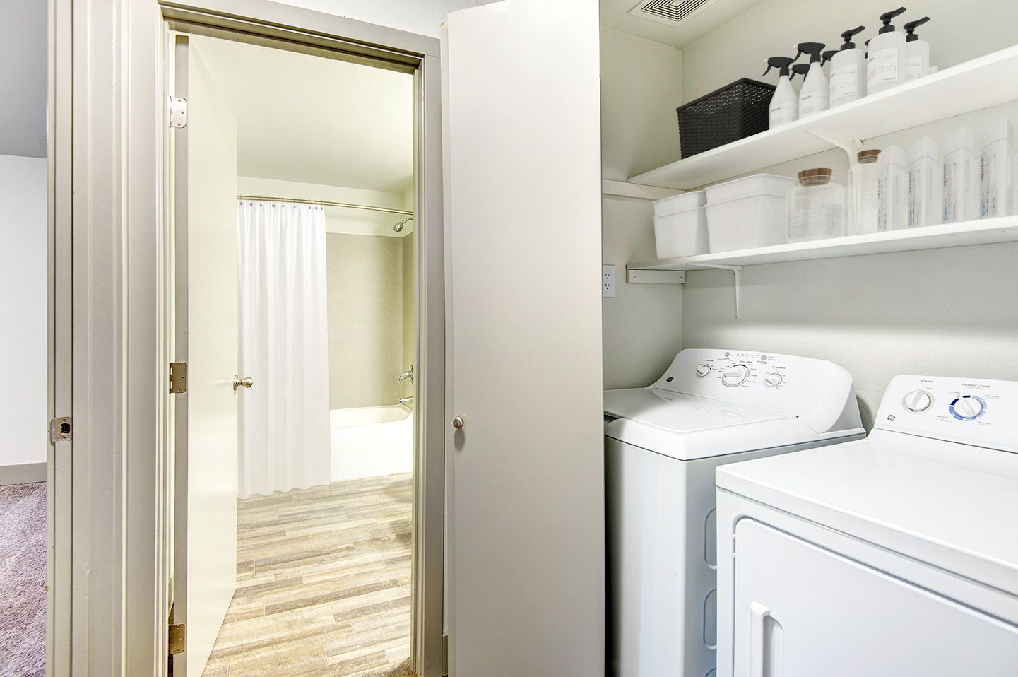 A laundry room with a washer and dryer in it.