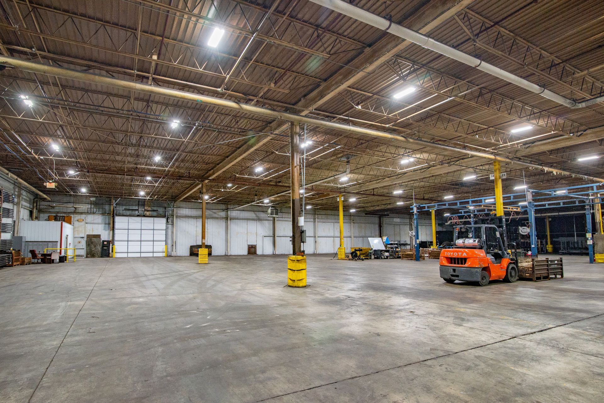 Large empty warehouse with a forklift.