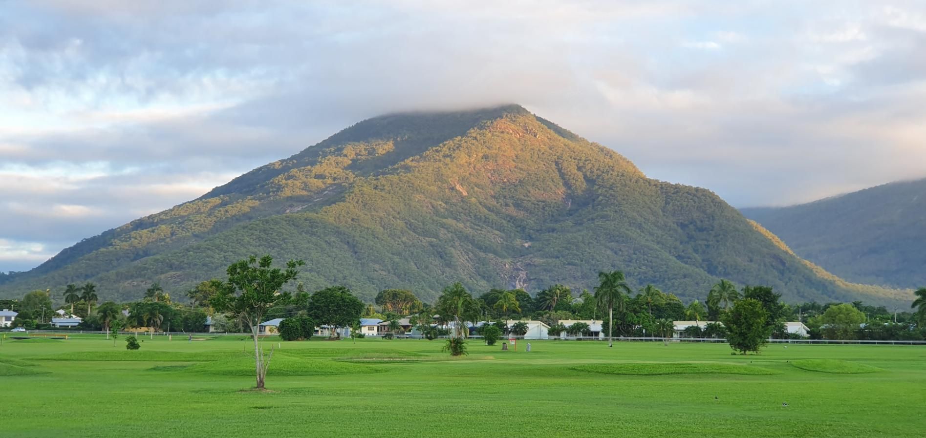 There Is a Mountain in The Background and A Field in The Foreground — Recharged Air & Electrical in Gordonvale, QLD