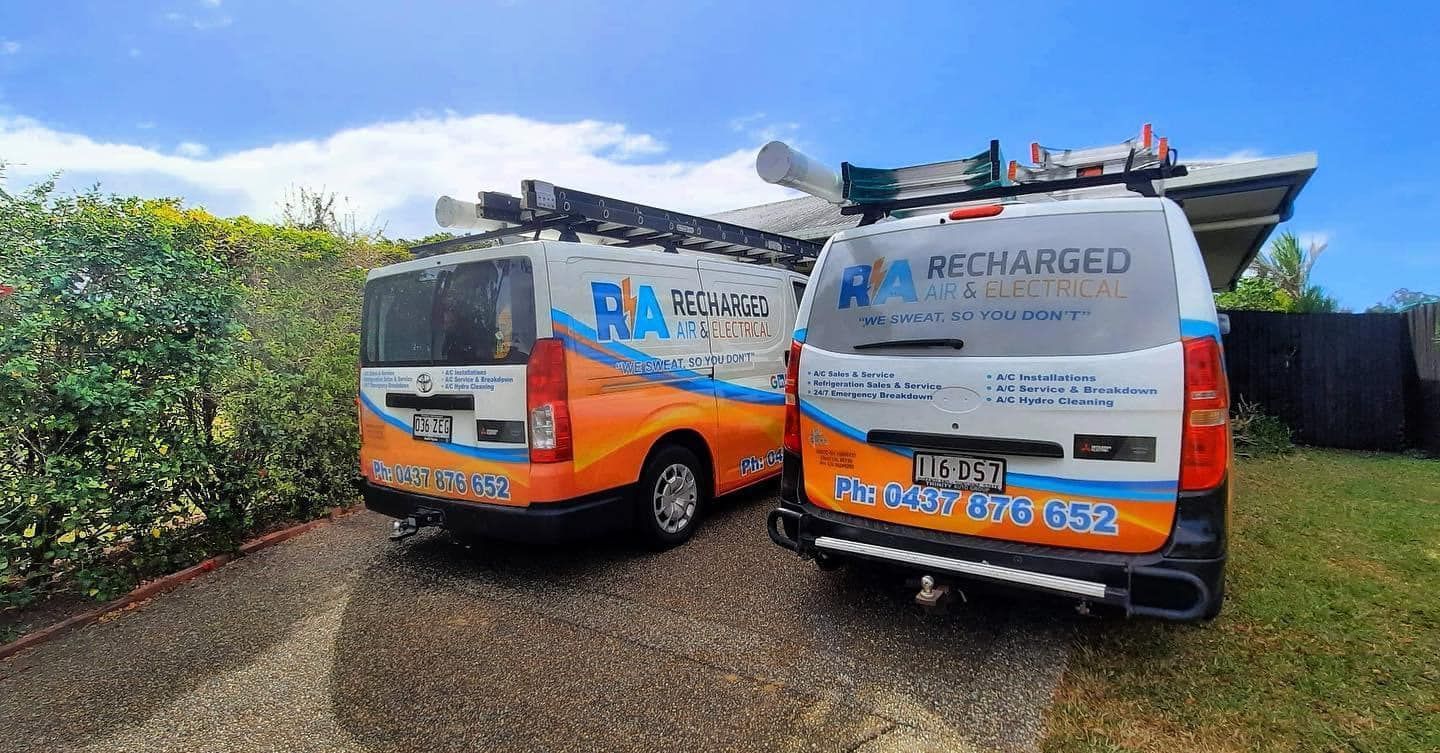 Two Vans Are Parked Next to Each Other on A Gravel Road — Recharged Air & Electrical in Atherton, QLD