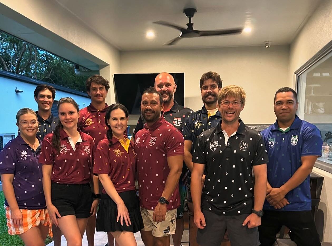 Group of people posing outdoors, many wearing team shirts — Recharged Air & Electrical in Stratford, QLD