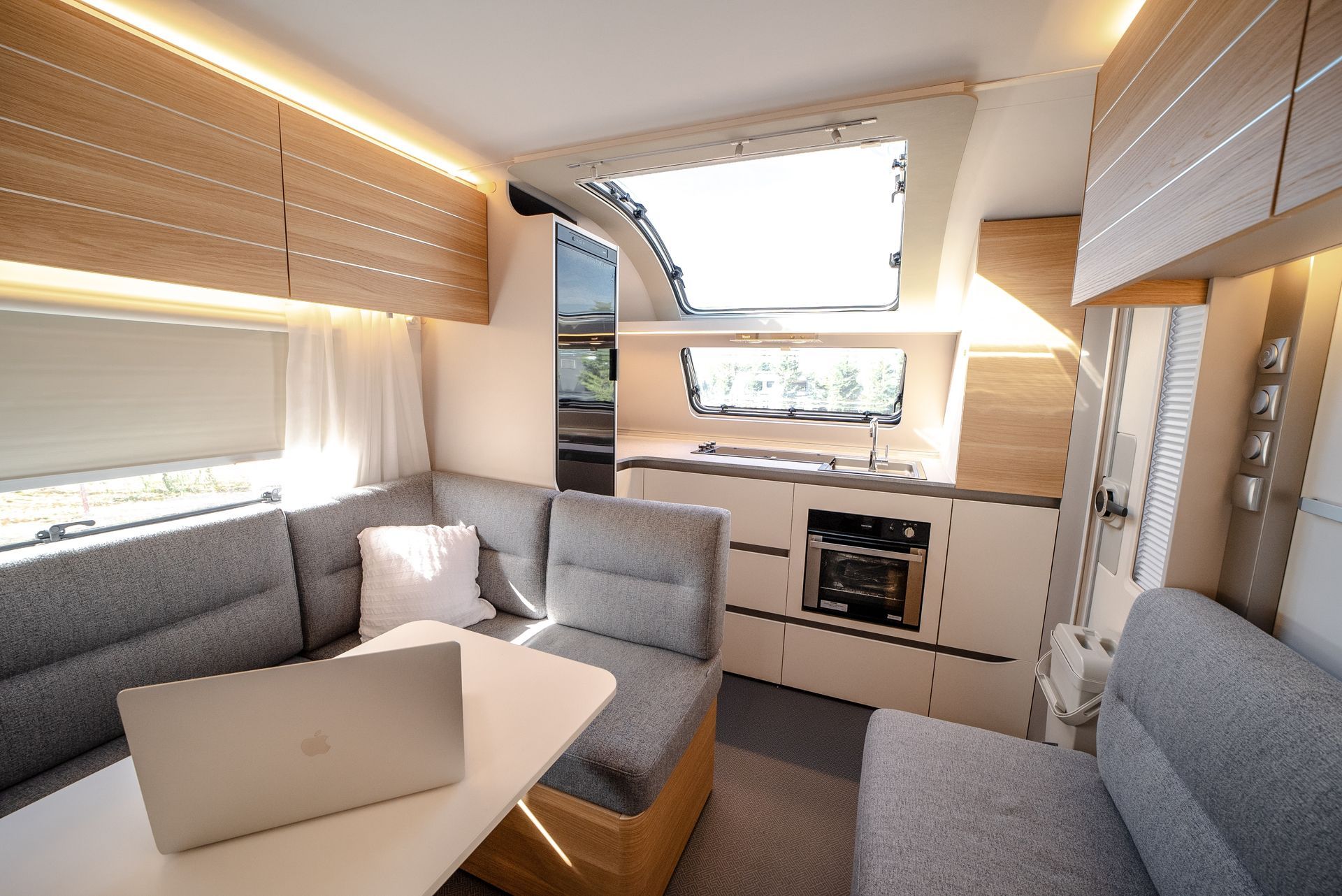 Interior of a modern camper van with a gray couch