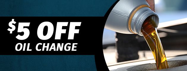 $5 off oil change with oil pouring from a bottle.