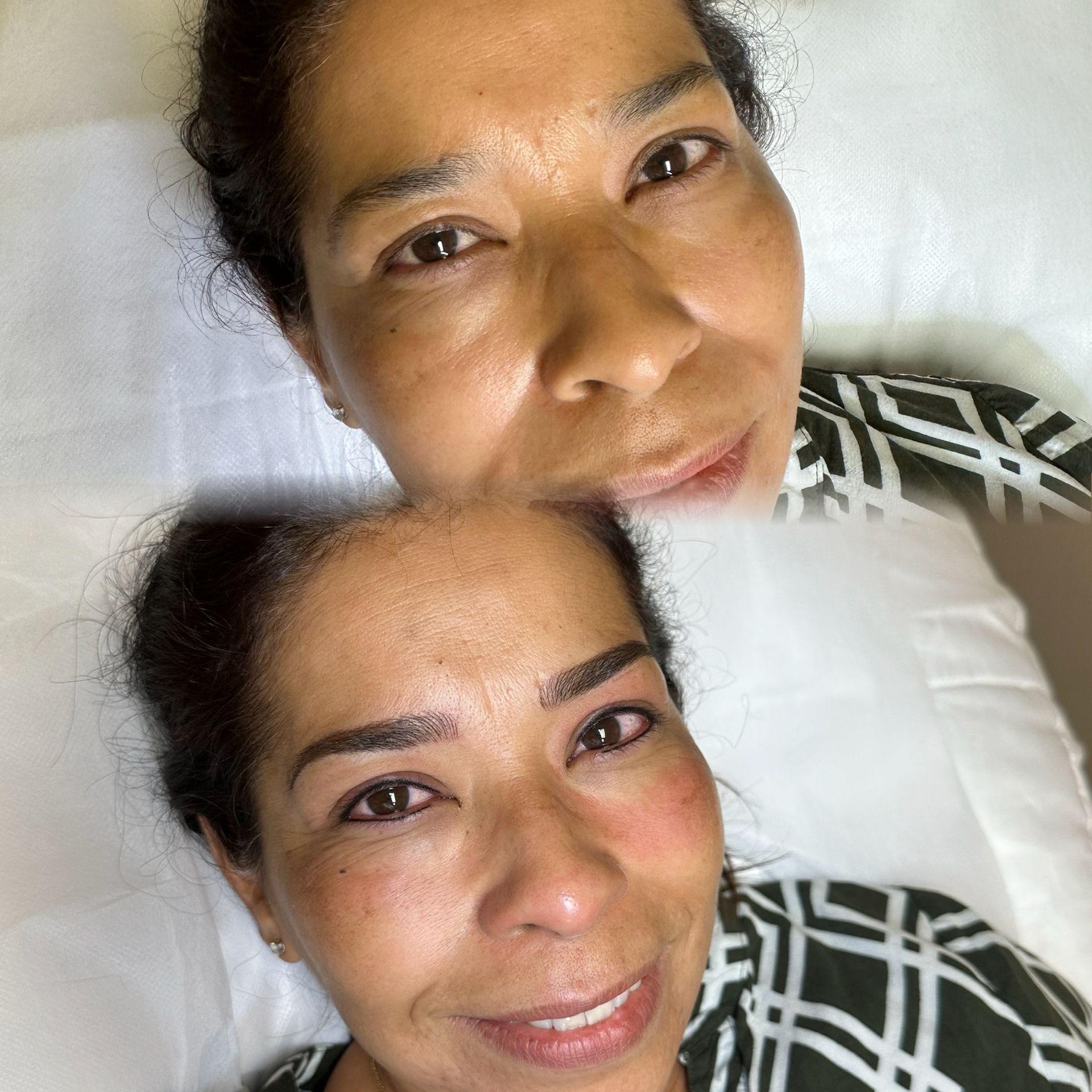 A woman is laying on a bed with her eyes closed and smiling.