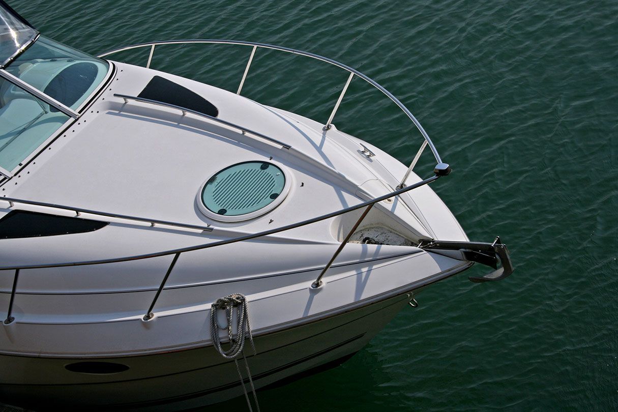 A white boat is docked in a body of water