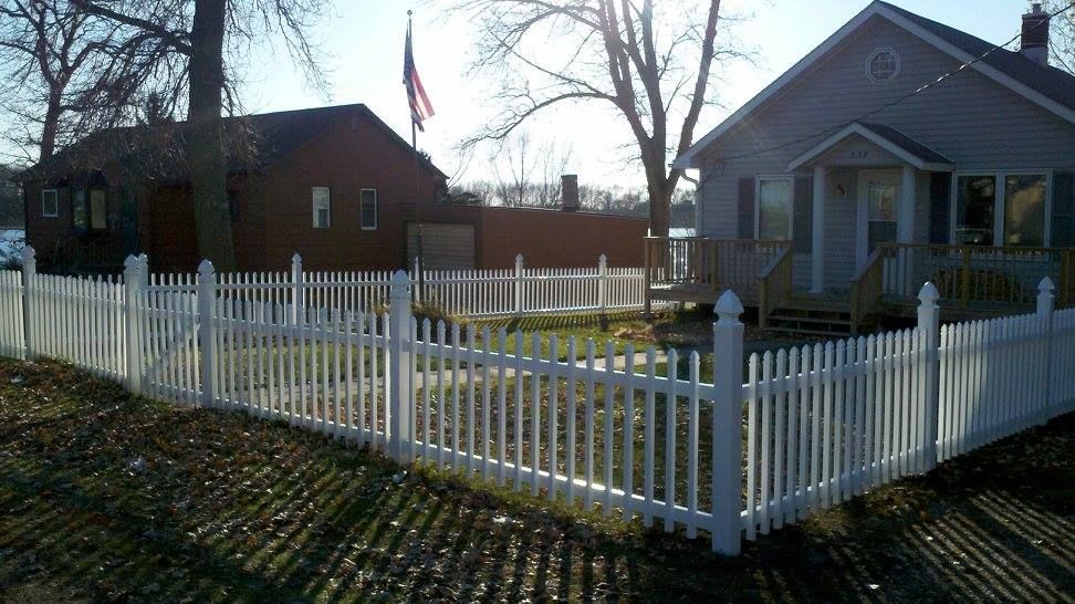 A house with a white picket fence in front of it