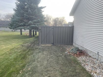 There is a fence between the house and the yard.
