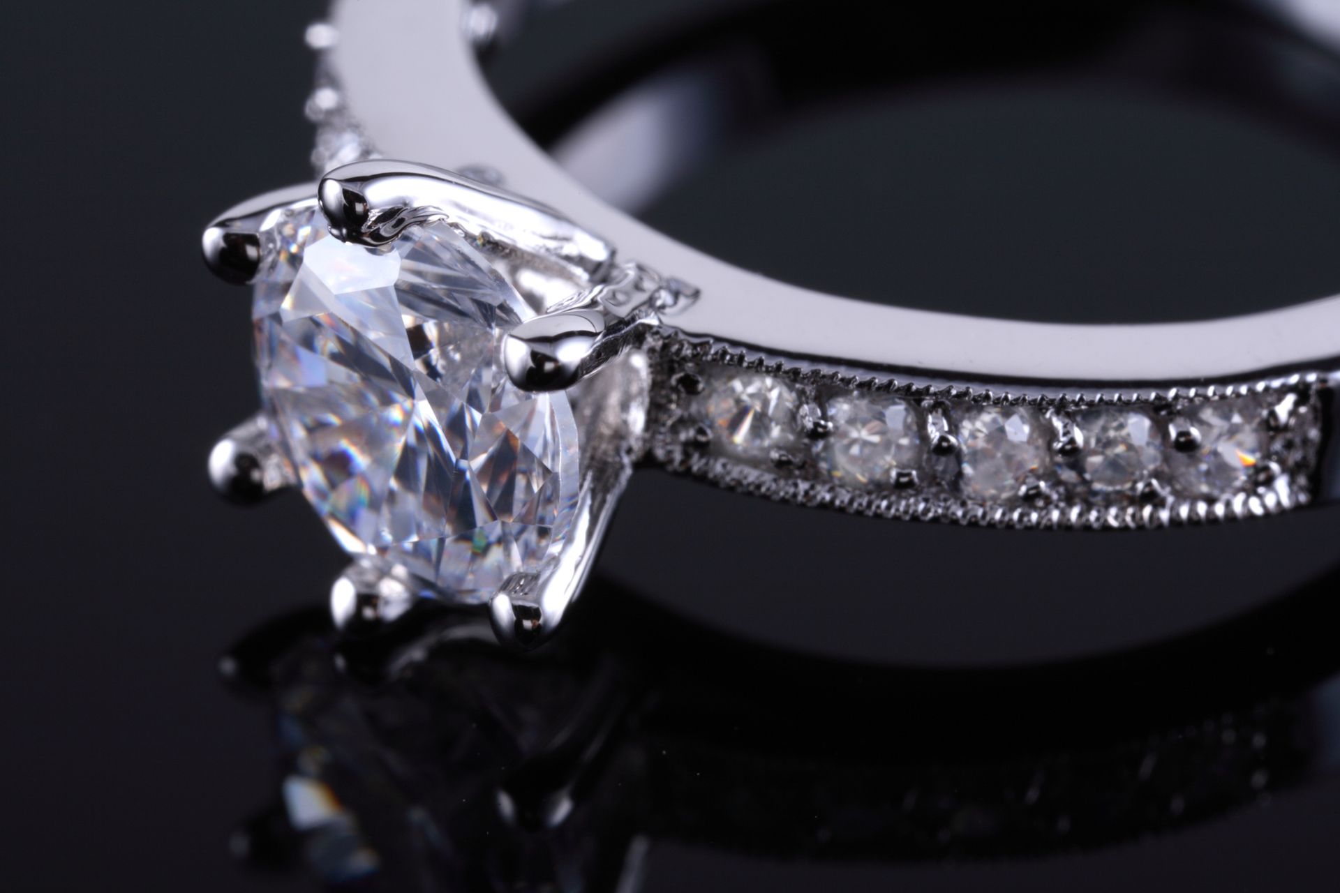 Macro shot of a white gold diamond ring sparkling with intricate details Macro shot of a white gold diamond ring sparkling with intricate details