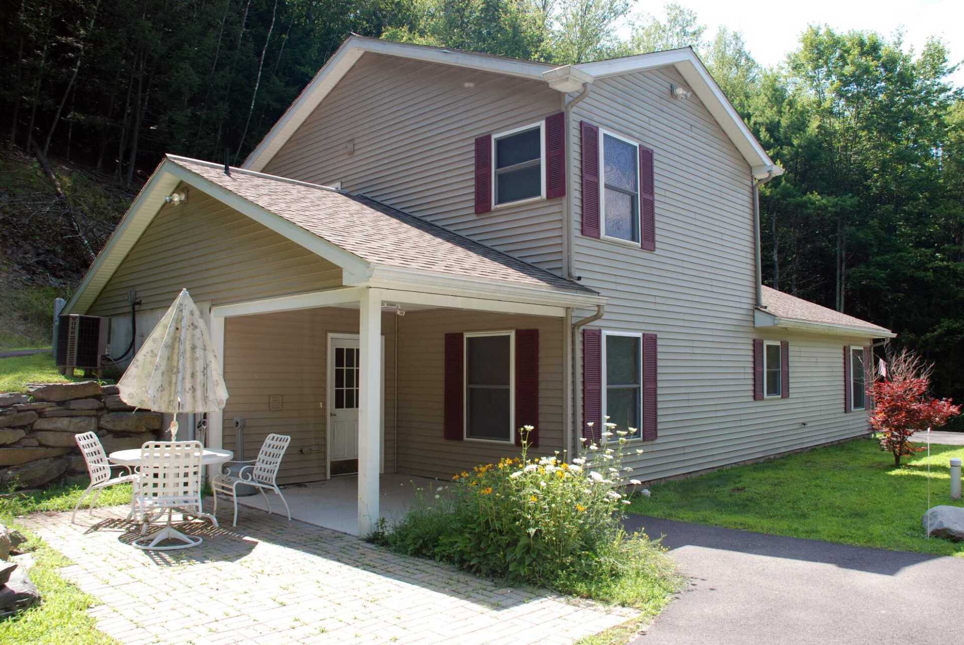 A house with a porch and chairs in front of it