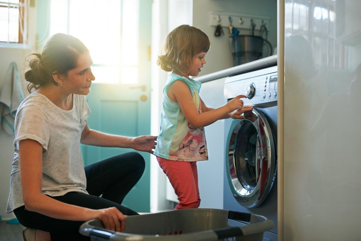 mother and daughter doing laundry