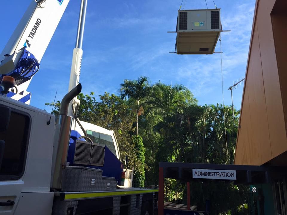 A Crane Is Lifting a Crane Above A Truck — The Cool Guys In Holtze, NT