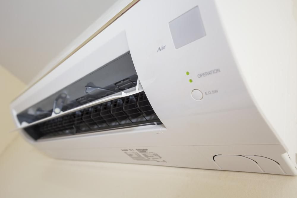 A White Air Conditioner is Hanging on a Wall — The Cool Guys In Holtze, NT