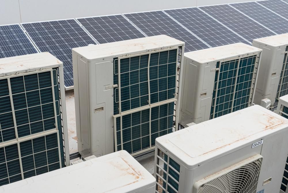 A Row of Air Conditioners and Solar Panels on the Roof of a Building — The Cool Guys In Humpty Doo, NT