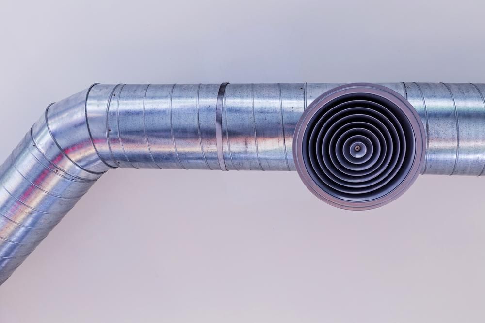 A Close Up of a Metal Pipe With a Round Hole in the Middle — The Cool Guys In Berrimah, NT