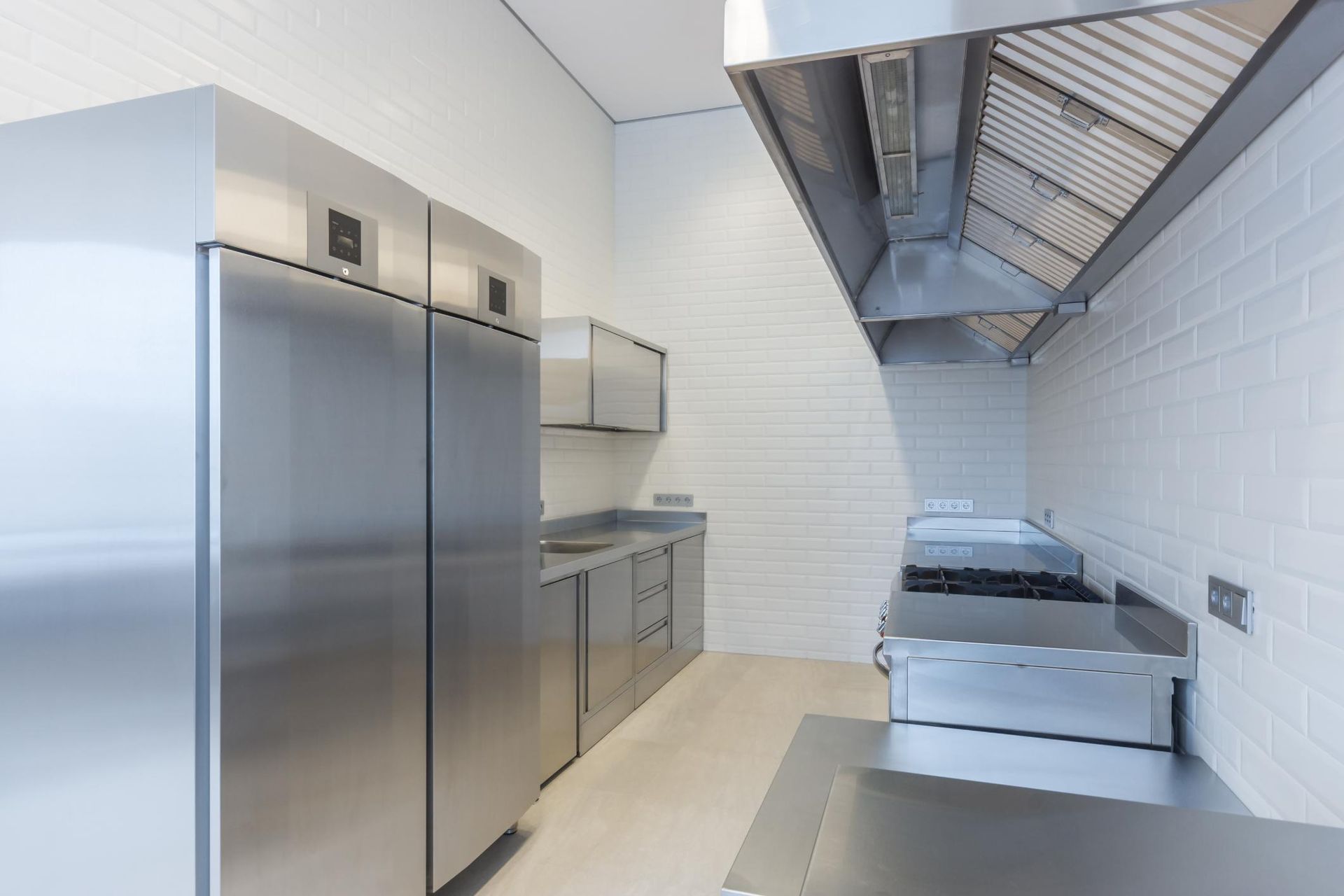 A Kitchen With Stainless Steel Appliances and a Stove — The Cool Guys In Berrimah, NT