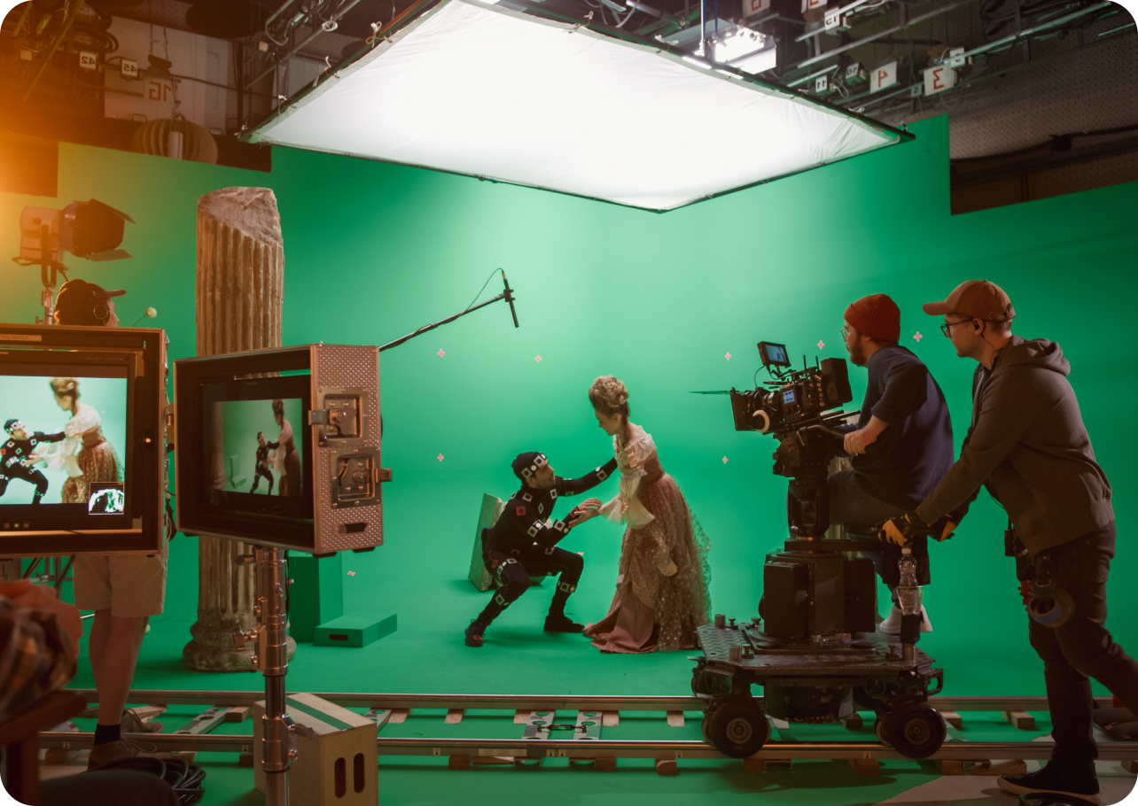 A group of people are standing in front of a green screen.