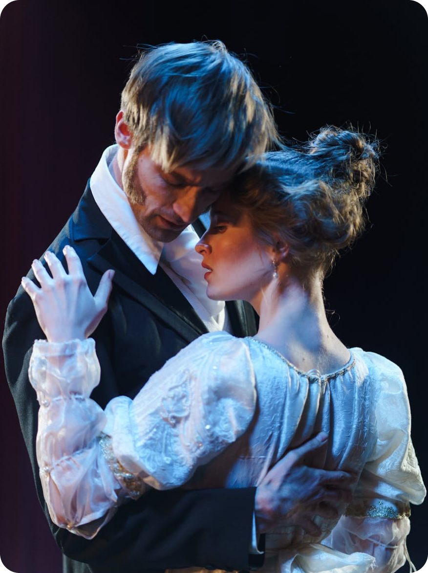 A man and a woman are dancing together on a stage