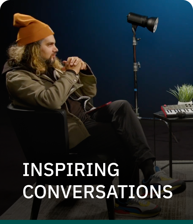 A man is sitting in a chair with the words inspiring conversations above him