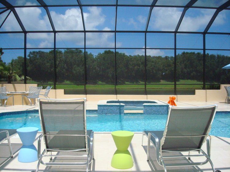 Lounge chairs under pool enclosure