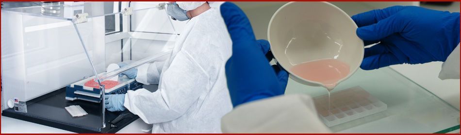A person in a lab coat is pouring liquid into a cup.