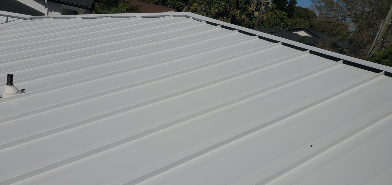 White metal roof with corrugated pattern, taken from above at an angle.
