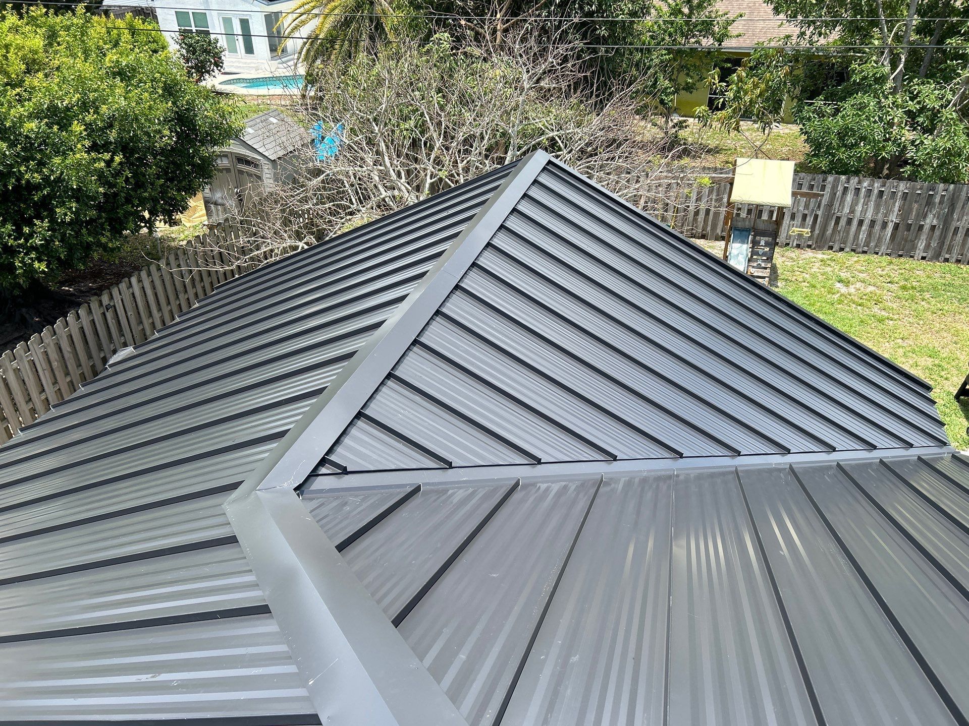 Gray metal roof with ridges, seen from above.