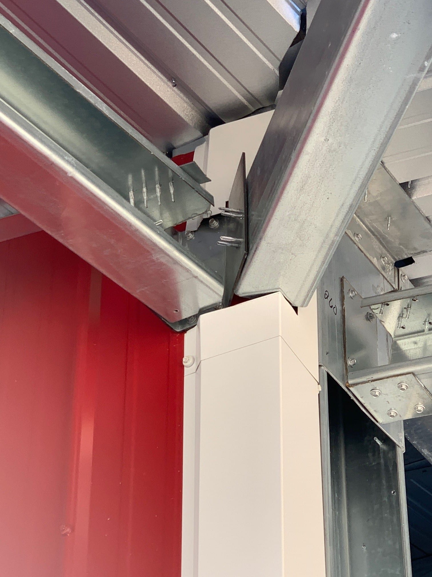Steel beams and red wall interior with a white support column.