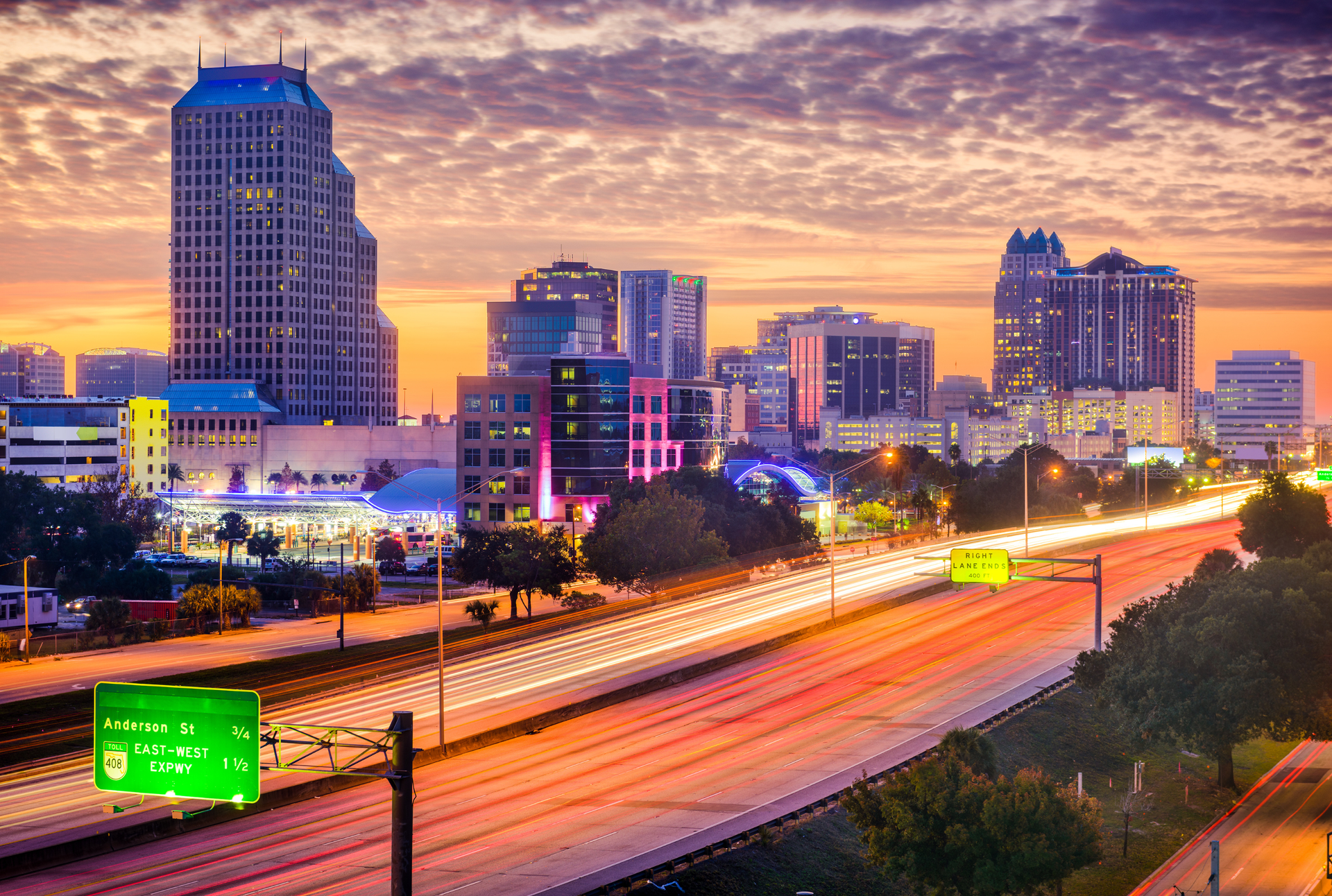 A gondola is floating down a canal in venice at sunset.