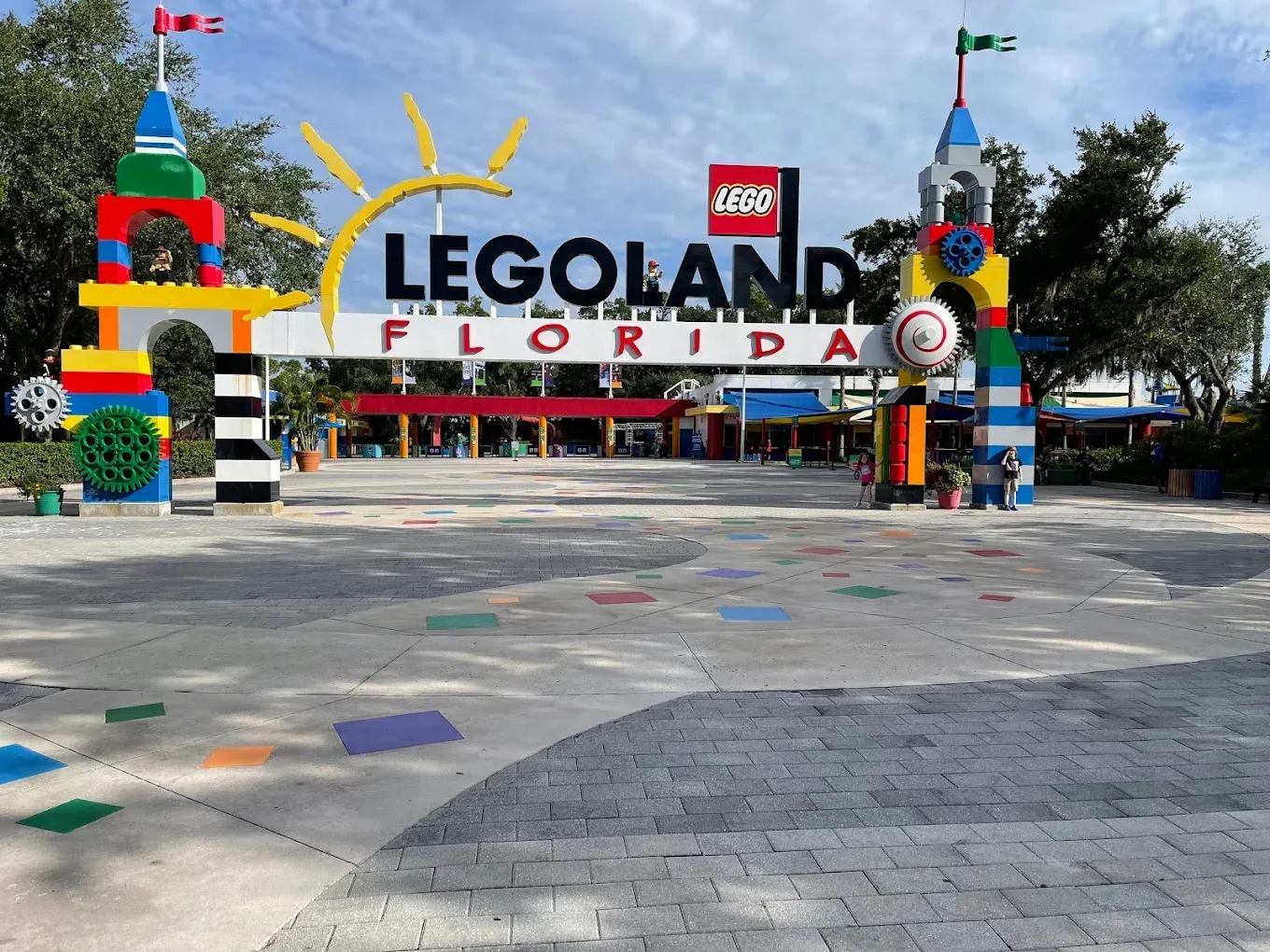 A sign for jurassic park is surrounded by trees