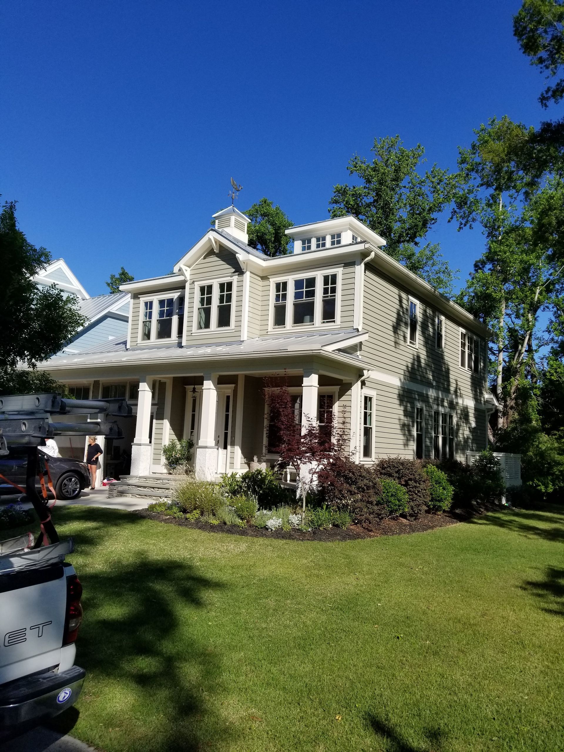 A large house with a truck parked in front of it