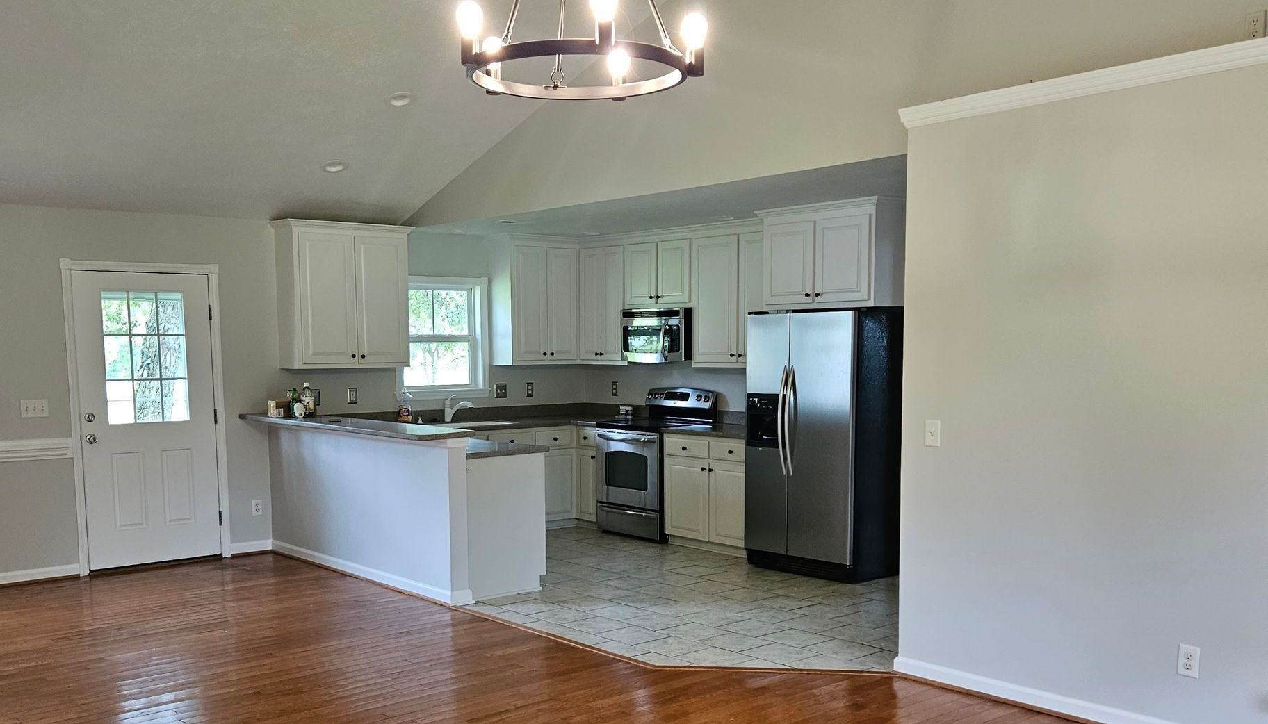 A kitchen with wooden cabinets and granite counter tops.
