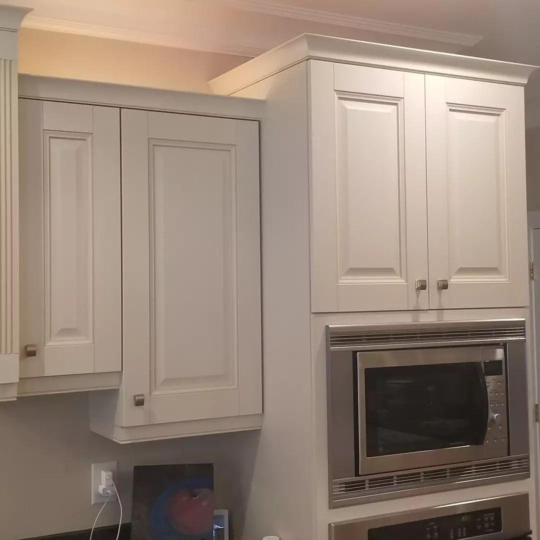 A kitchen with white cabinets and blue counter tops is being remodeled.