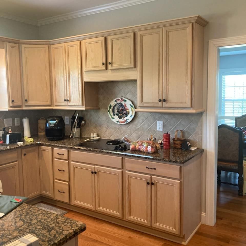 A kitchen with wooden cabinets and granite counter tops.